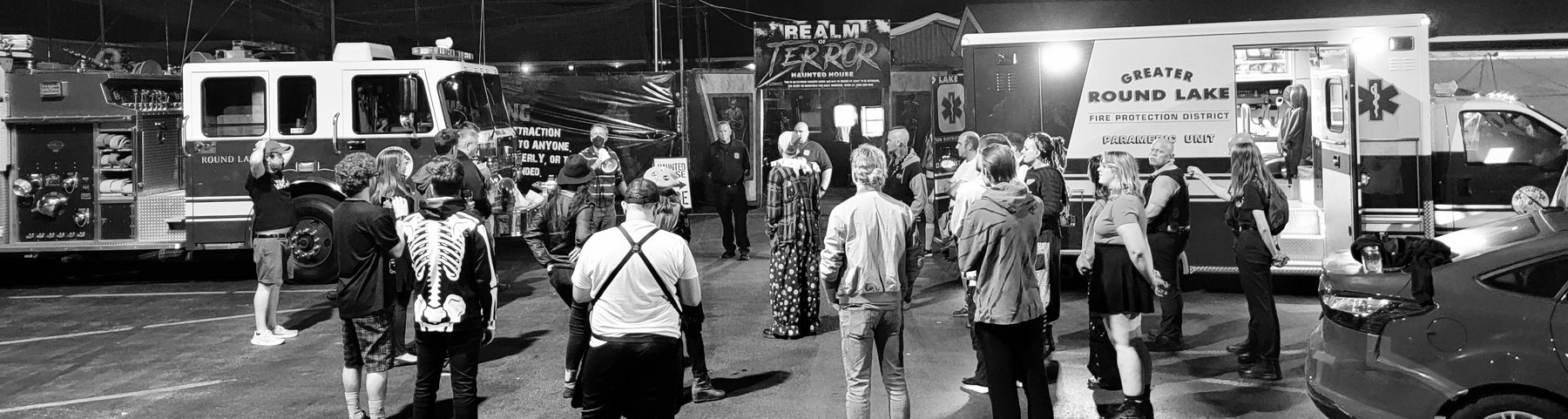 Production staging with emergency vehicles outside Realm of Terror.