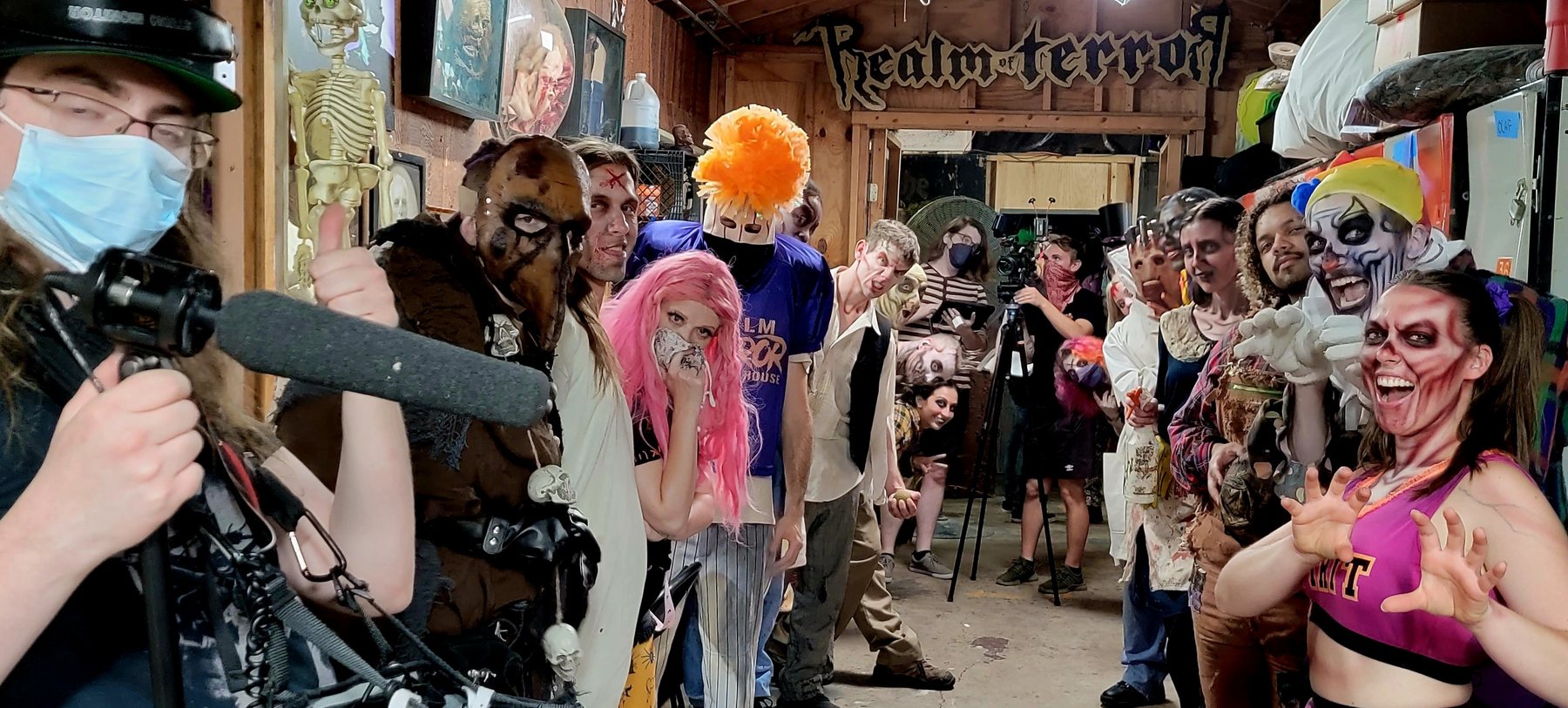 Camera and cast gathered near the Realm of Terror entrance during production.