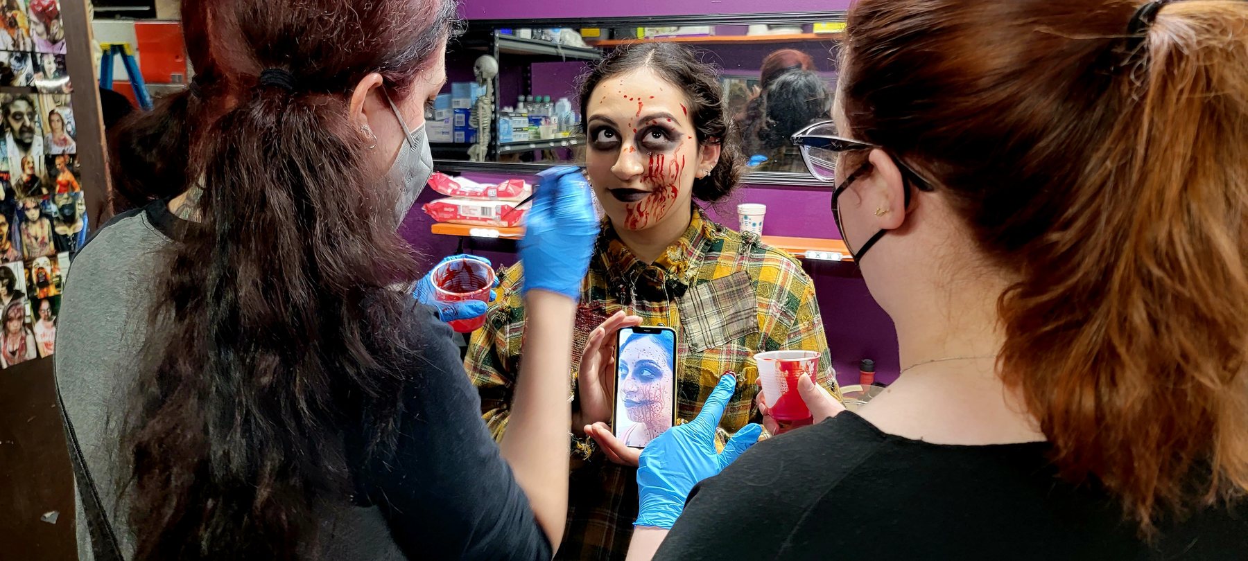 Elizabeth Cannon and Isabella Cernuska working on Janet Jurado's effects makeup.