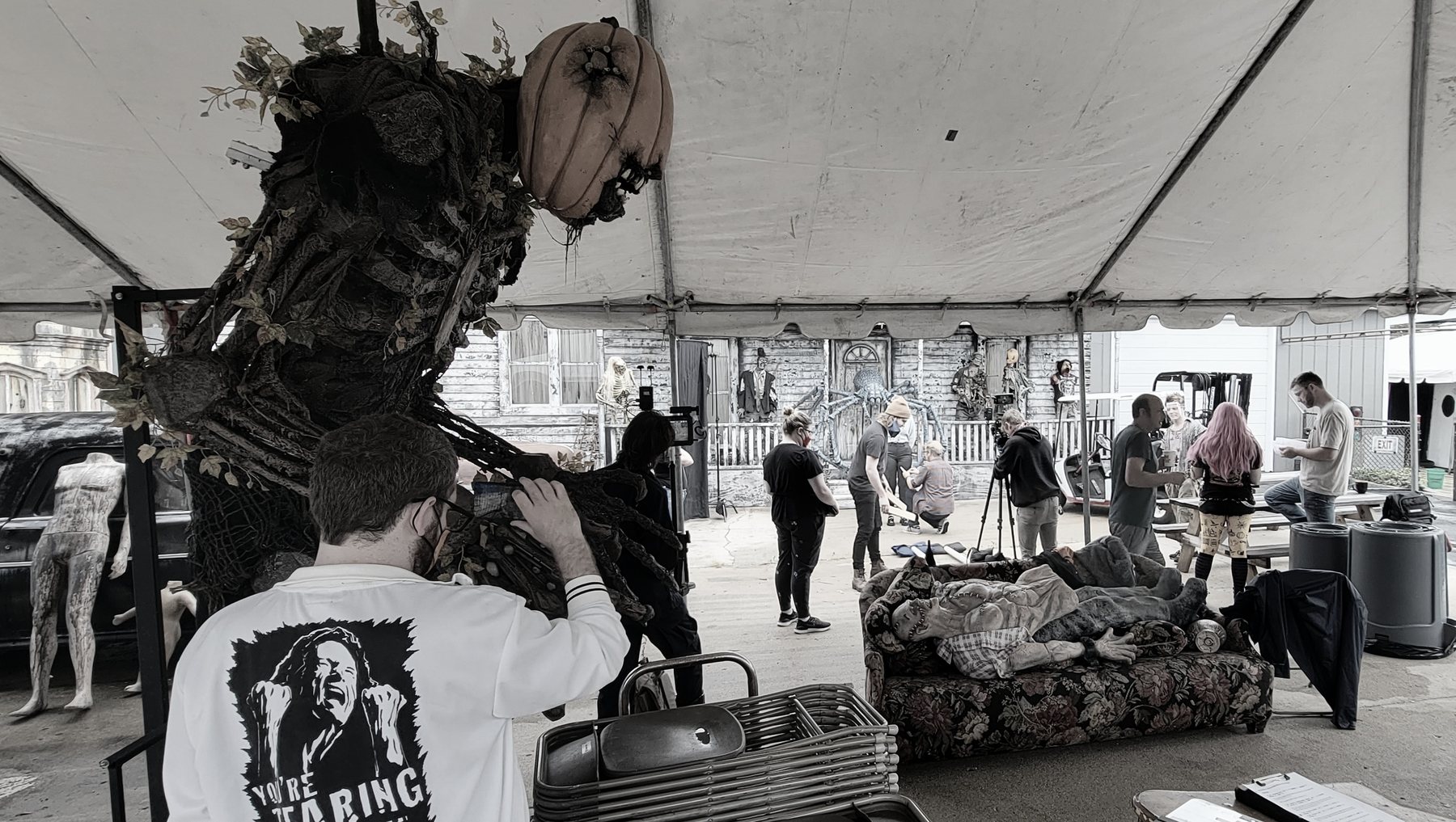 A costumed character and crew working between setups during Haunt Season.