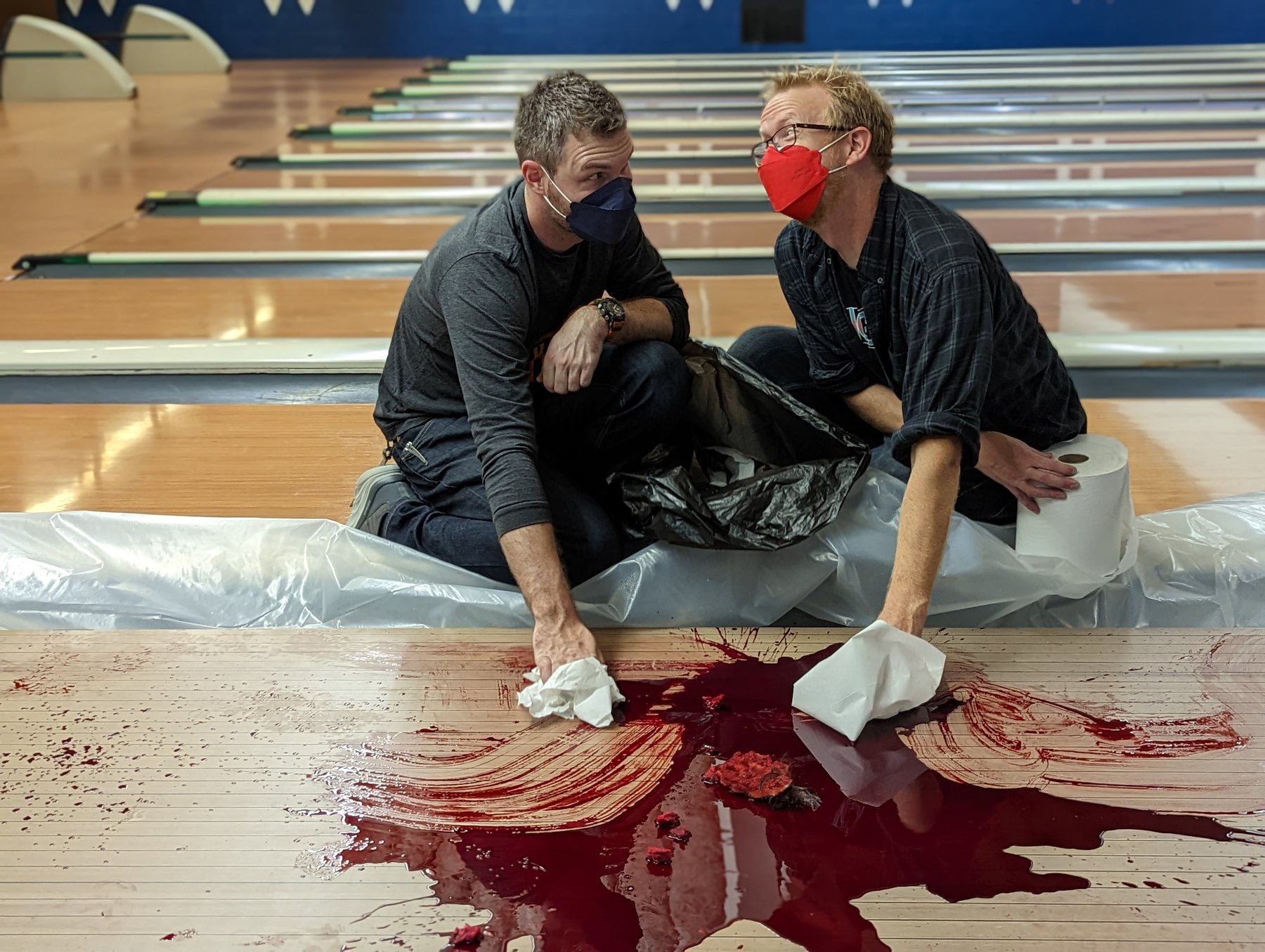 Stephen Kristof and director Jake Jarvi cleaning up after a bowling-alley effects scene.