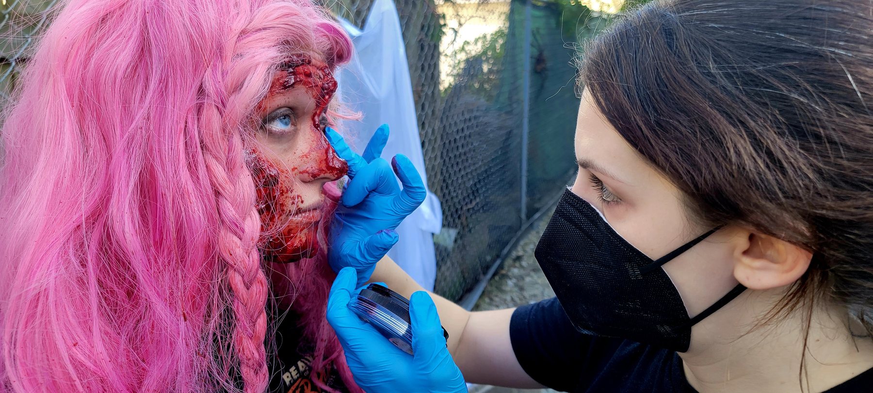 Stevie Calabrese applying practical-effects makeup to Katelin Stack.