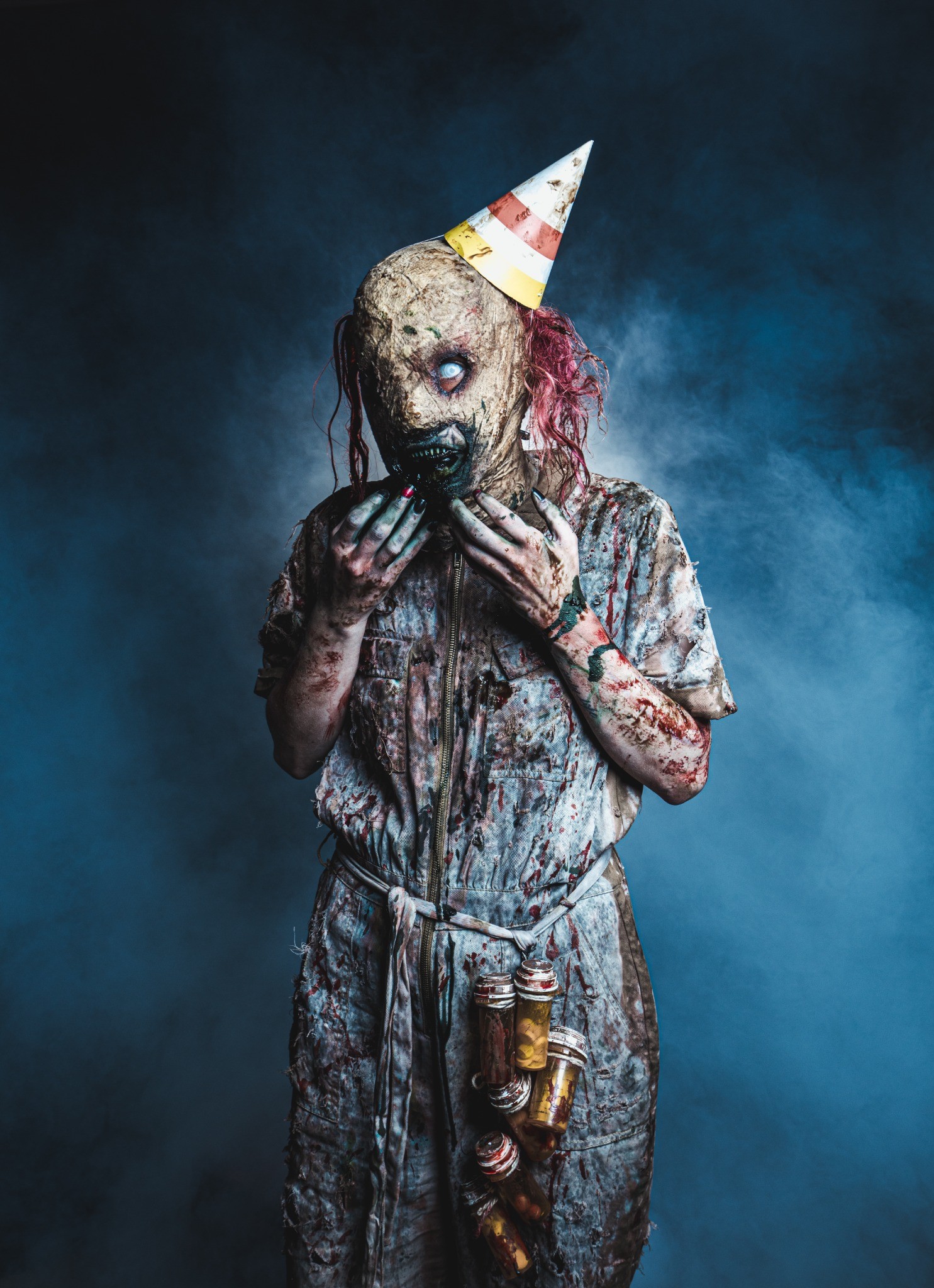 Realm of Terror masked party-hat character portrait in blue theatrical fog