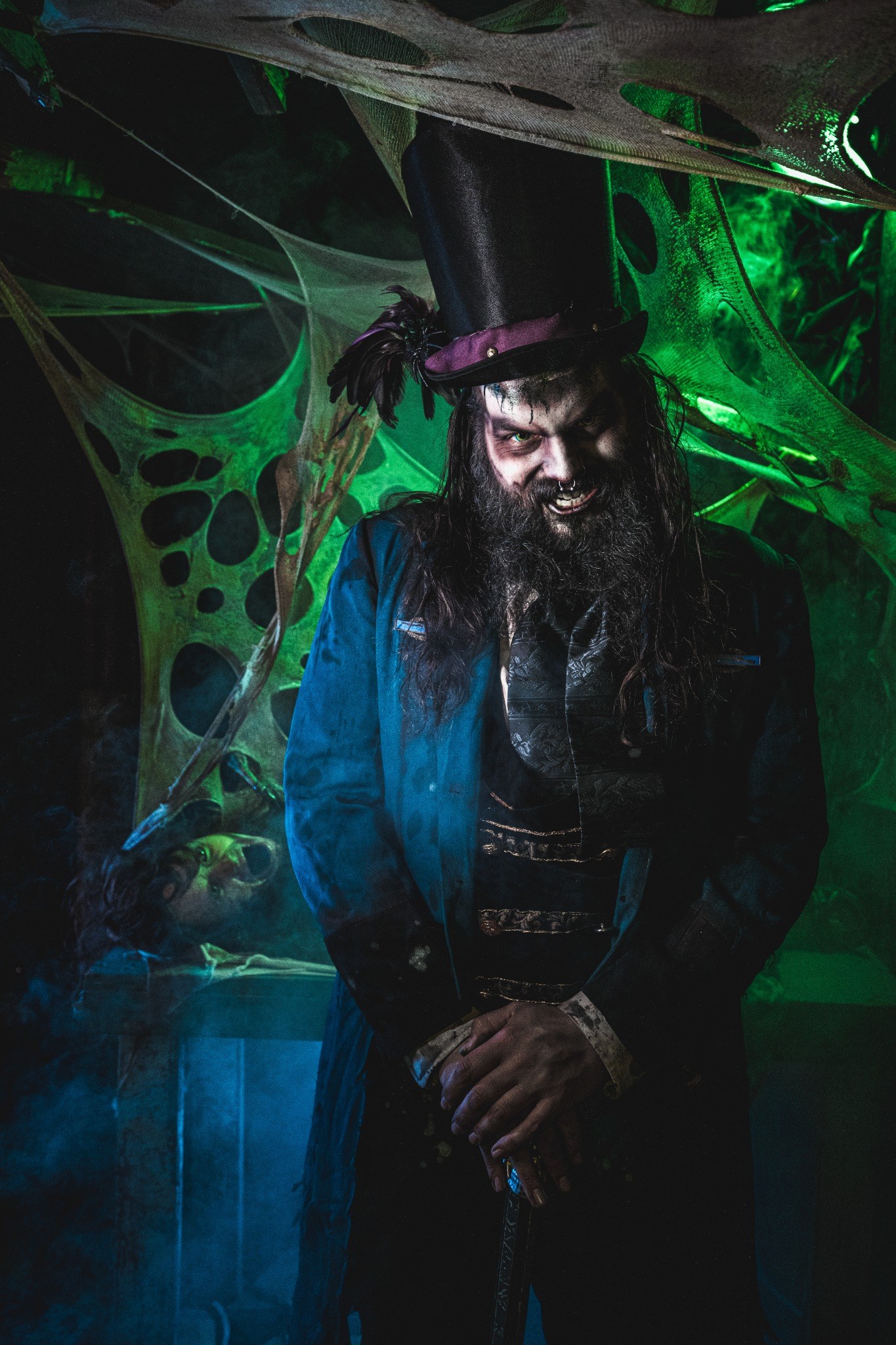 Top-hat character inside a green web-filled Realm of Terror environment